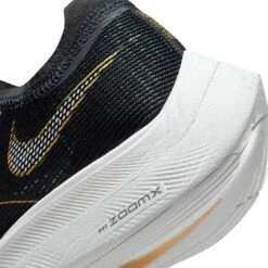 Nike Women's ZoomX Vaporfly Next % 2 Racing Shoe - Black/White/Metallic Gold Coin - Regular (B) 17 Nike Women's ZoomX Vaporfly Next % 2 Racing Shoe - Black/White/Metallic Gold Coin - Regular (B) -Shoe Sale Shop CU4123 001 PHSYD002 1500